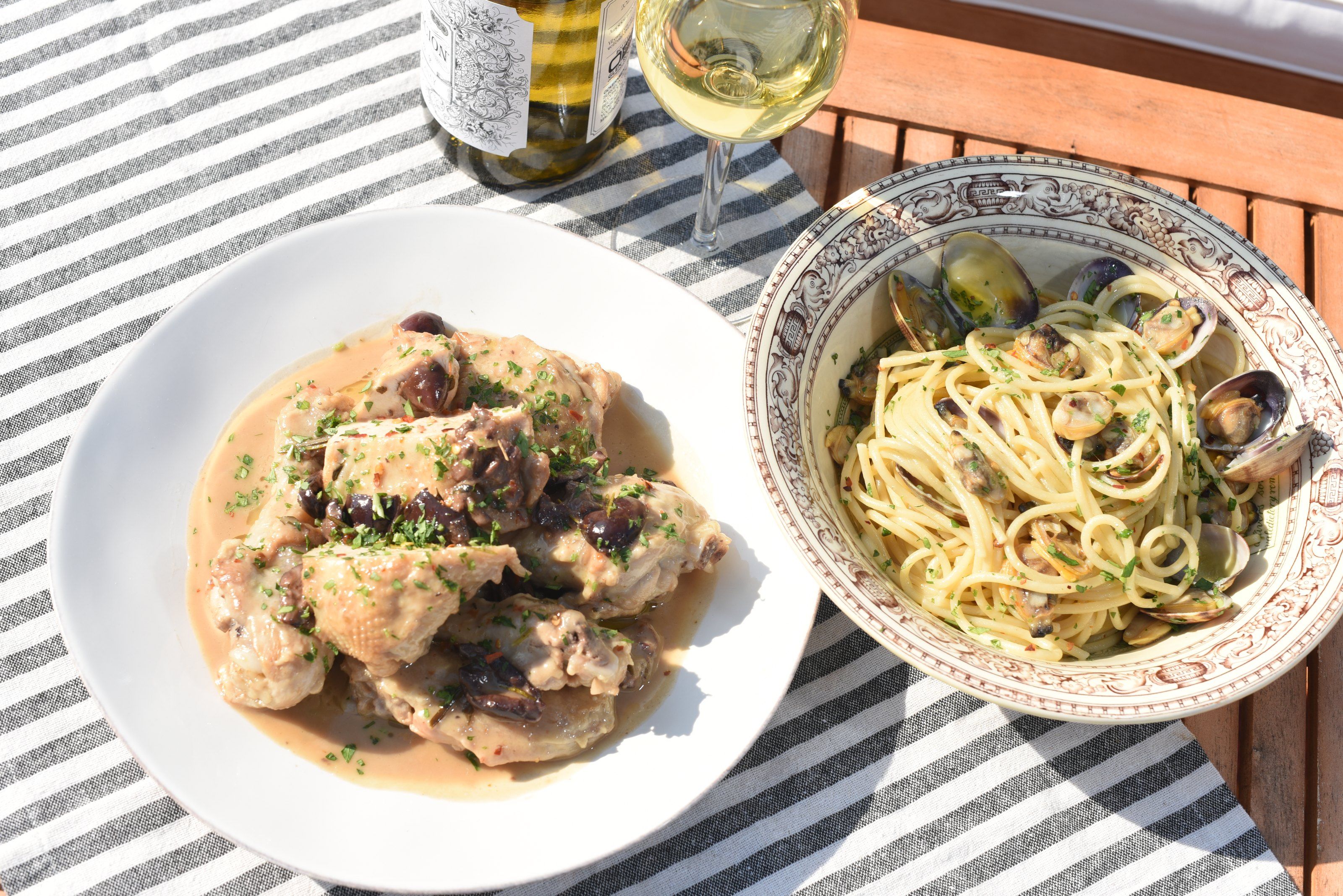 Chicken cacciatora with olives on a white plate, seen from above